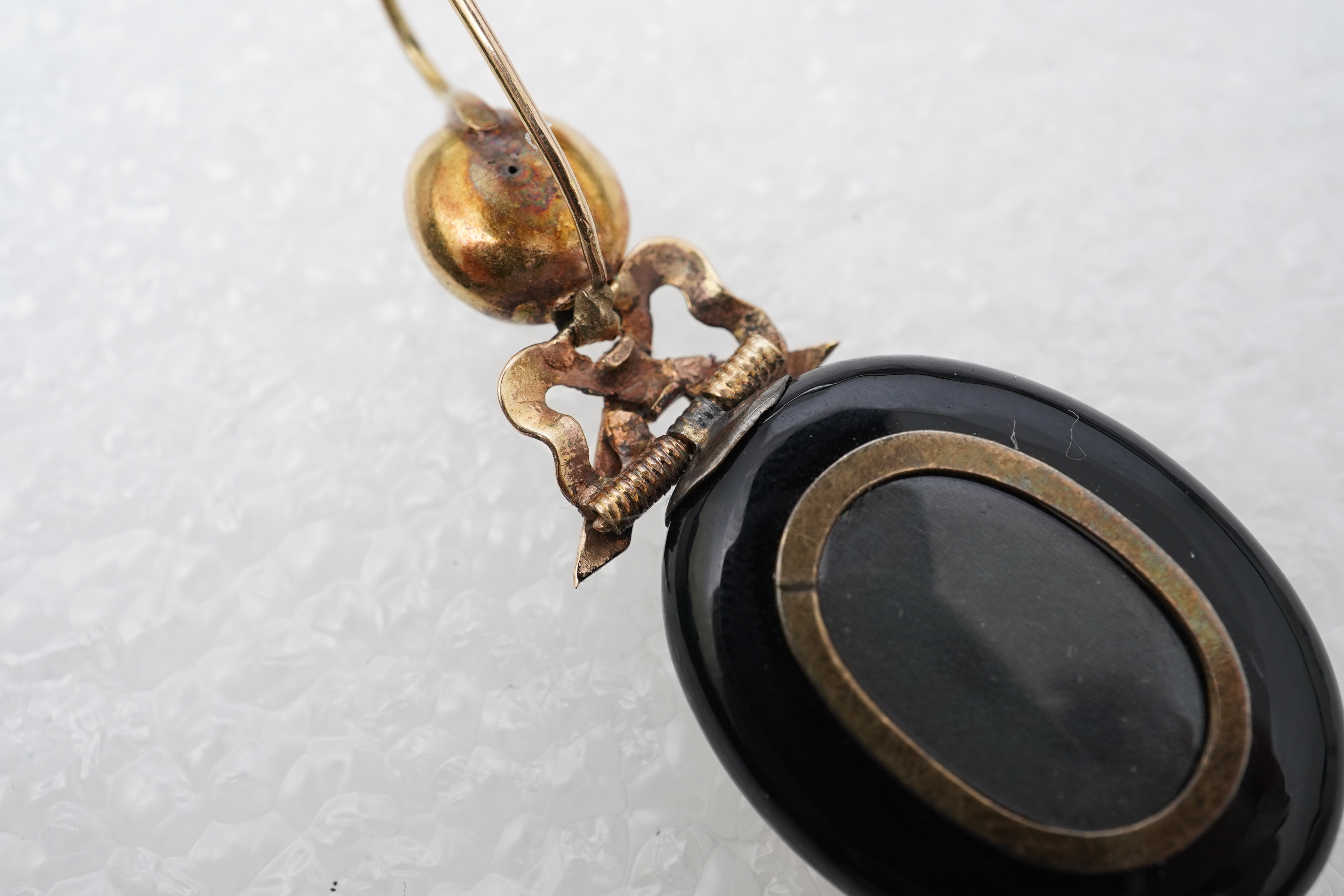 An onyx and seed pearl mourning locket pendant, late 19th century